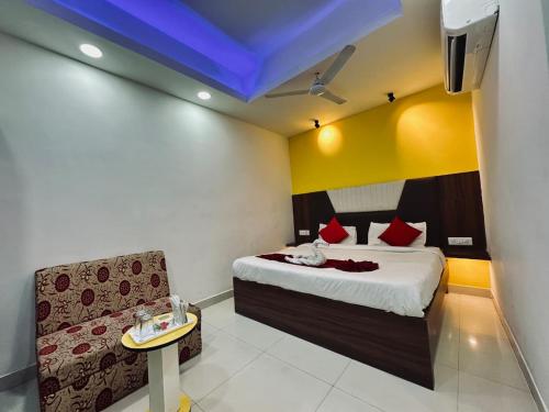 a hotel room with a bed and a couch at Kanha Gold in Bhopal