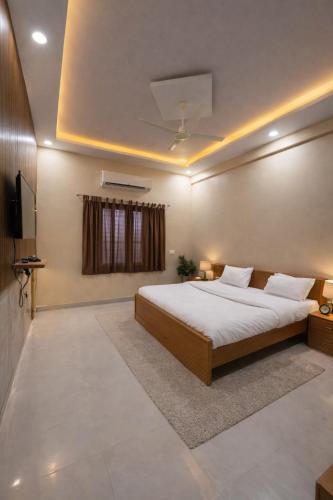 a bedroom with a large bed and a television at Udaigarh Palace - The Heritage Hotel in Jodhpur