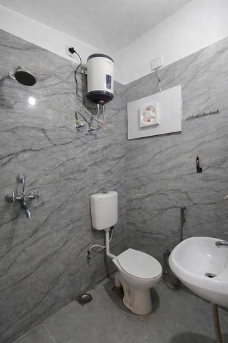 a bathroom with a toilet and a sink at Udaigarh Palace - The Heritage Hotel in Jodhpur