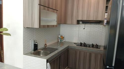 a kitchen with a sink and a counter top at Villa Casa Delta Canggu in Canggu
