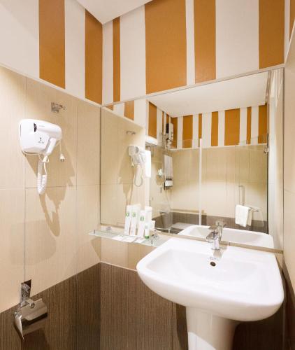 a bathroom with a sink and a mirror at Hotel101 - Fort in Manila
