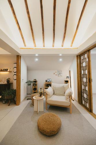 a living room with a chair and a table at Bow Hanok House in Gangneung