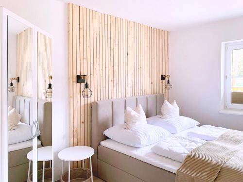 a bedroom with a bed with white pillows at Ferienwohnung Perle im Grünen - Urlaub an der Müritz in Federow