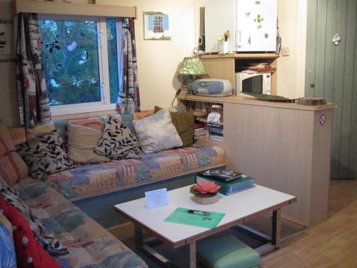 a living room with a couch and a coffee table at Ty Bihan de L'Aber in Crozon