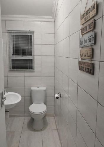 a bathroom with a toilet and a sink at At last in Pearly Beach