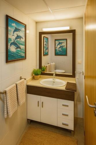 a bathroom with a sink and a mirror at RelaxMaria in Sant Carles de la Ràpita