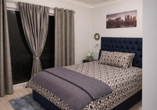 a bedroom with a bed and a window at At last in Pearly Beach