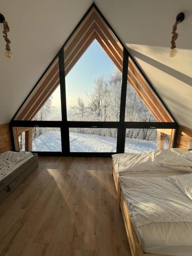 a room with a large window in a house at Chata u Przewodnika in Ostrowsko