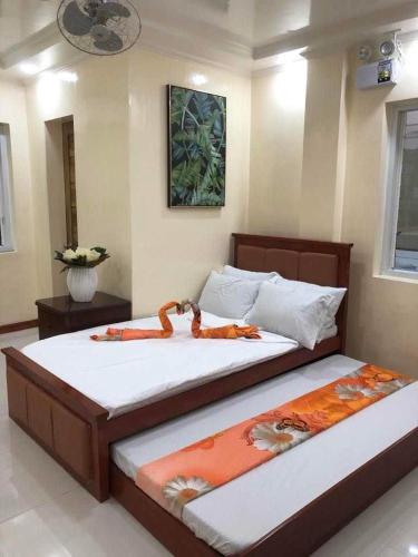 two twin beds in a room with at LUMBAYAN BEACH RESORT in Dawis