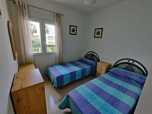 a bedroom with two beds and a window at Casa Mila in El Verger