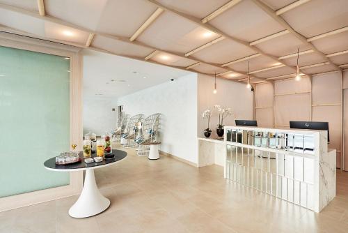a room with a table and bottles of wine at Eurostars Ibiza in Ibiza Town