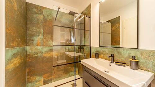 a bathroom with a sink and a mirror at Villa Lana by Villas Guide in Vela Luka