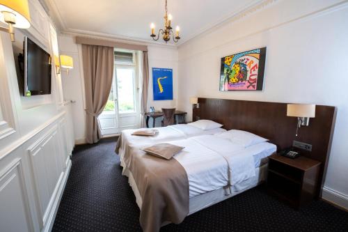 a hotel room with a bed and a television at Hotel Helvetie Montreux in Montreux