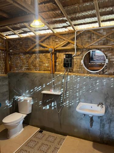 a bathroom with a toilet and a sink at Mook Mellow Hill Bungalows in Ko Mook