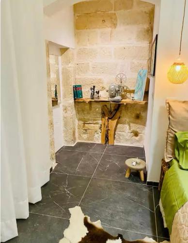 a bathroom with a sink and a table in a room at Dongiovanni Suite in Lecce