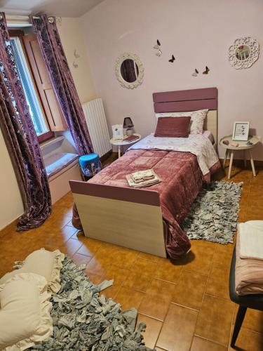 a bedroom with a bed and a rug at Da Caterina alla piccola cascata in Antrodoco