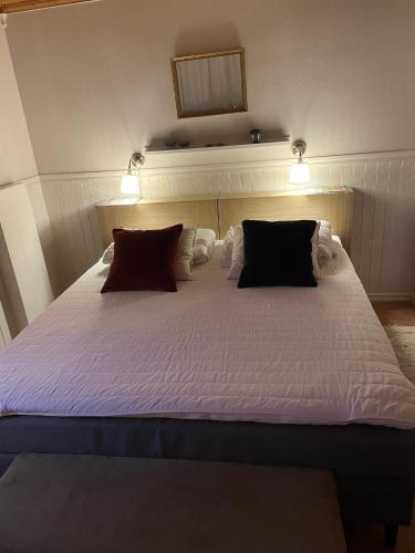 a bedroom with a large white bed with two pillows at Nästeviken Björkhaget in Nästeviken