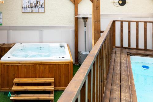 a hot tub in a room with a wooden deck at וילה לה מונטנייה in Dāliyat el Karmil