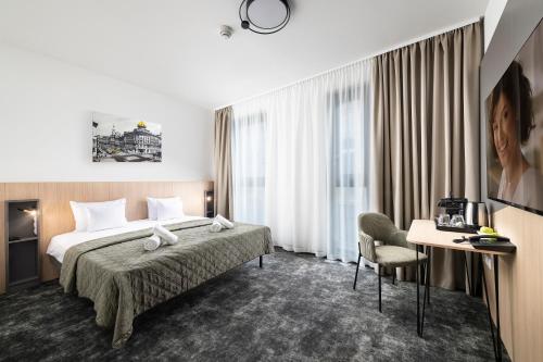 a hotel room with a bed and a desk at Bo18 Hotel Superior in Budapest