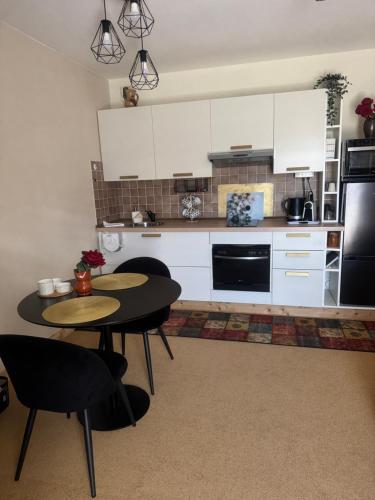 a kitchen with two tables and white cabinets at Belle Vue de St Gervais in Saint-Gervais-les-Bains