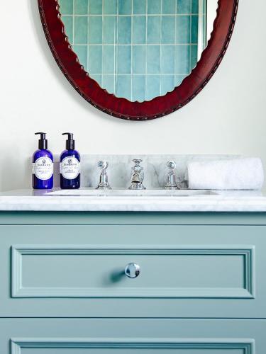 a bathroom sink with two bottles of soap on it at Dumbarnie East Cottage in Kirkton of Largo