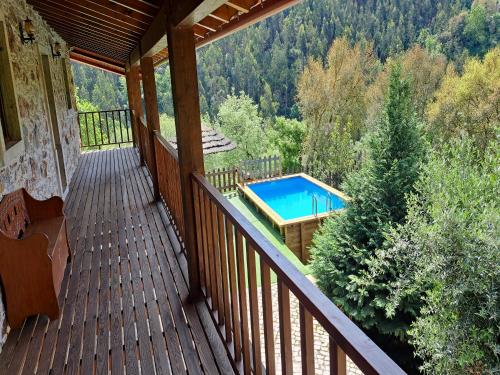 a balcony of a house with a swimming pool at Casa Velha in Figueiró dos Vinhos