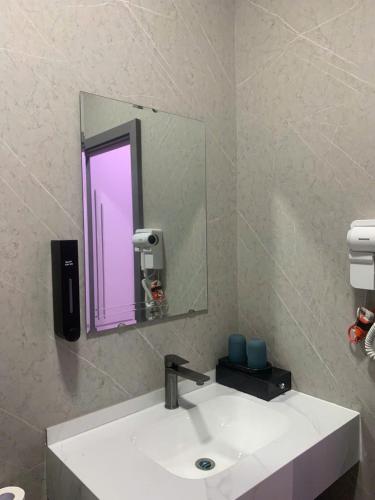a bathroom with a white sink and a mirror at 1993 Homestay G&C Quảng Trị in Quang Tri