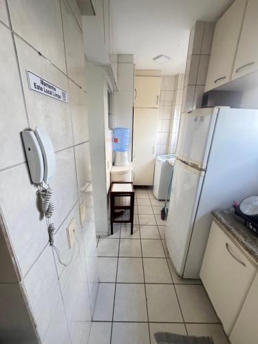 a kitchen with a refrigerator and a tiled floor at Lar da Galega Espinheiro in Recife
