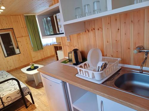a kitchen with a dish rack on the counter at Elmona Villas in Kamchia