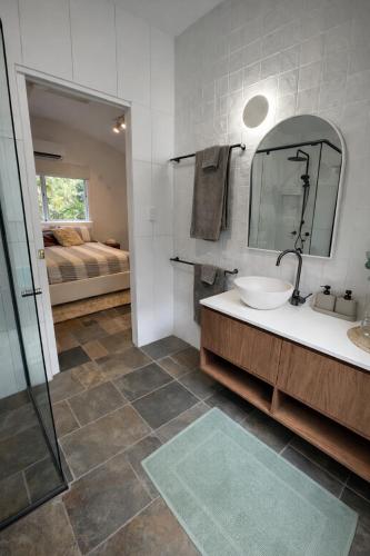 a bathroom with a sink and a mirror at Private Rainforest Guesthouse in Doonan in Doonan