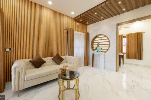 a living room with a couch and a table at Reunion Ocean Hridayam - Beach House in Udupi