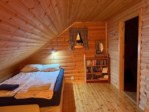 a bedroom with a bed in a wooden cabin at Camp Oinas in Hammerfest
