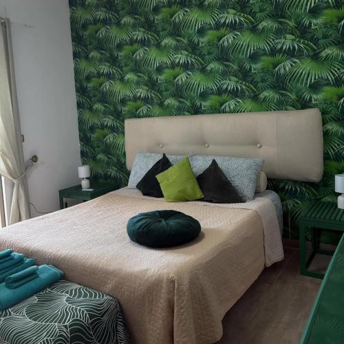 a bedroom with a bed with a green wall at Al Passo di Thalia in Ricadi