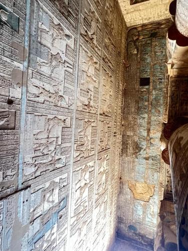 a wall with writing on the side of a building at ElMena House Luxor in Luxor