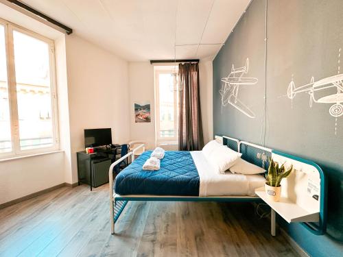 a bedroom with a bed and a wall with drawings on it at Ostello Bello Genova in Genoa