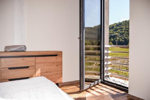 a bedroom with a large window with a view at Chata Zingoty in Mýto pod Ďumbierom