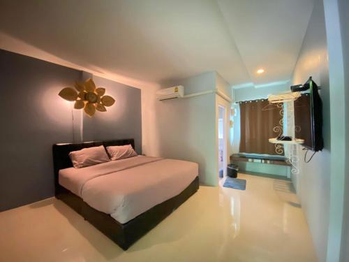a bedroom with a bed and a flat screen tv at Wang nam yen hill วังน้ำเย็นฮิลล์ in Ban Mai
