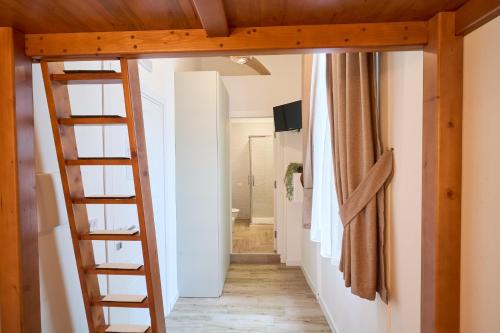 a room with a ladder leading to a hallway at Toto e Peppino Luxury Rooms in Naples