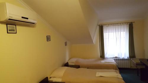 a room with two beds and a window at Zielony Dworek in Kraśnik