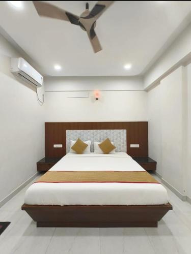a bedroom with a large bed in a room at Sathya Comforts in Bangalore