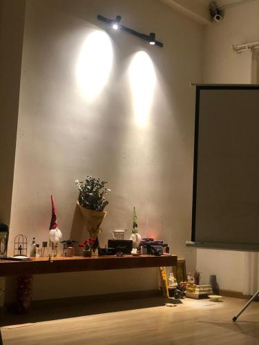 a room with a projection screen and a table with a podium at Nhà 5 PM in Da Thien