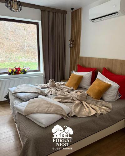 a large bed in a bedroom with a window at Forest Nest in Krayni Dol