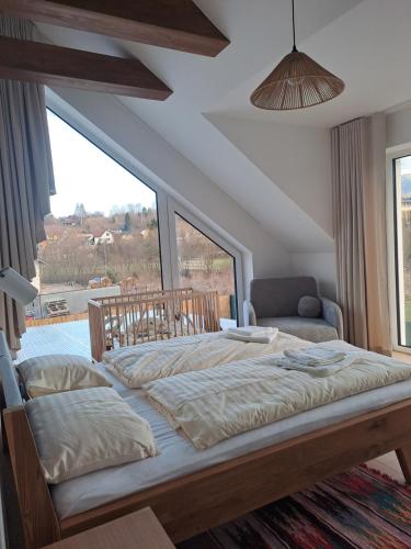 a bedroom with a large bed and a couch at Chata Za Studeným potokom in Habovka