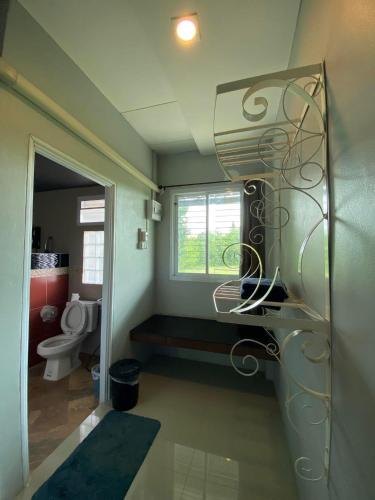 a bathroom with a toilet and a glass shelf at Wang nam yen hill วังน้ำเย็นฮิลล์ in Ban Mai
