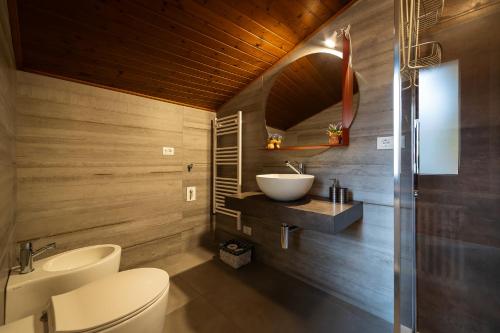 a bathroom with a white toilet and a sink at Alla Casa Medievale in Cividale del Friuli