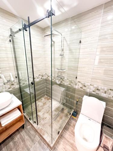 a bathroom with a shower and a toilet at AYUB Modern & Heritage HOTEL in Bukhara