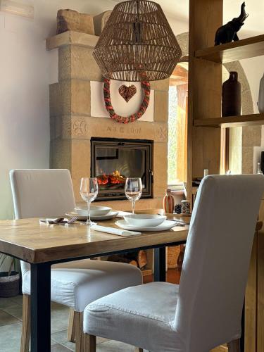 a dining room with a table with chairs and a fireplace at Posada El Azufral - Adults only - Smoke-Free in Cambarco