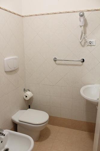 a bathroom with a toilet and a sink at Agrimar in Magliano Romano