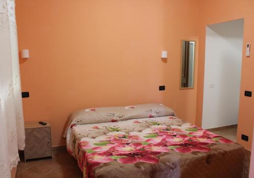a bedroom with a bed with flowers on it at Agrimar in Magliano Romano