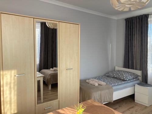 a small bedroom with a bed and a closet at Agroturystyka u Witka in Brynica Mokra